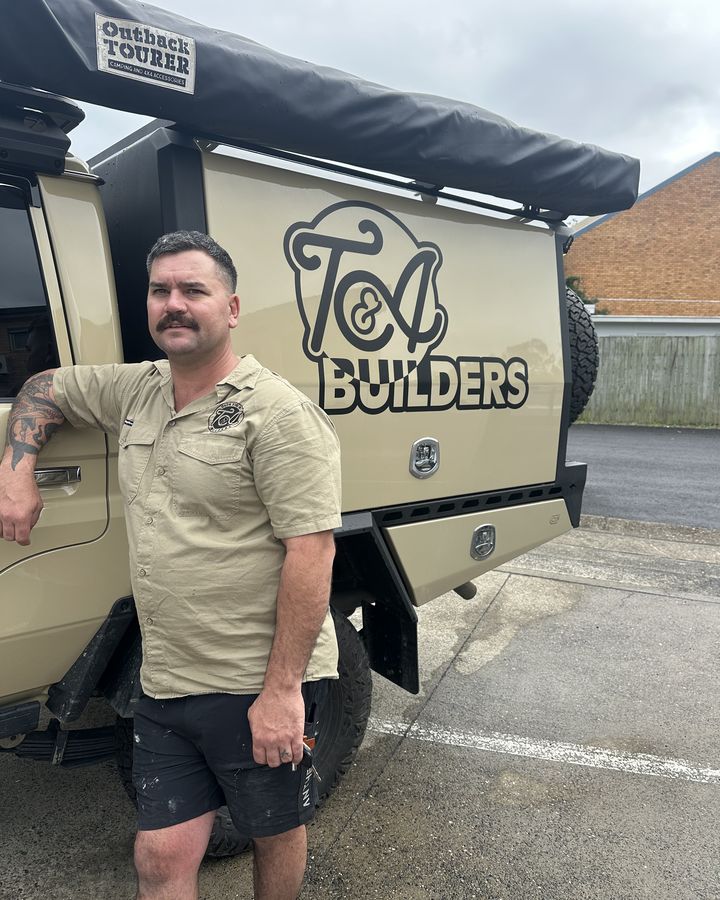 Trent Kennedy standing beside the T&A Builders ute